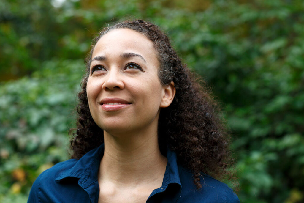 Mixed race woman in nature, smiling