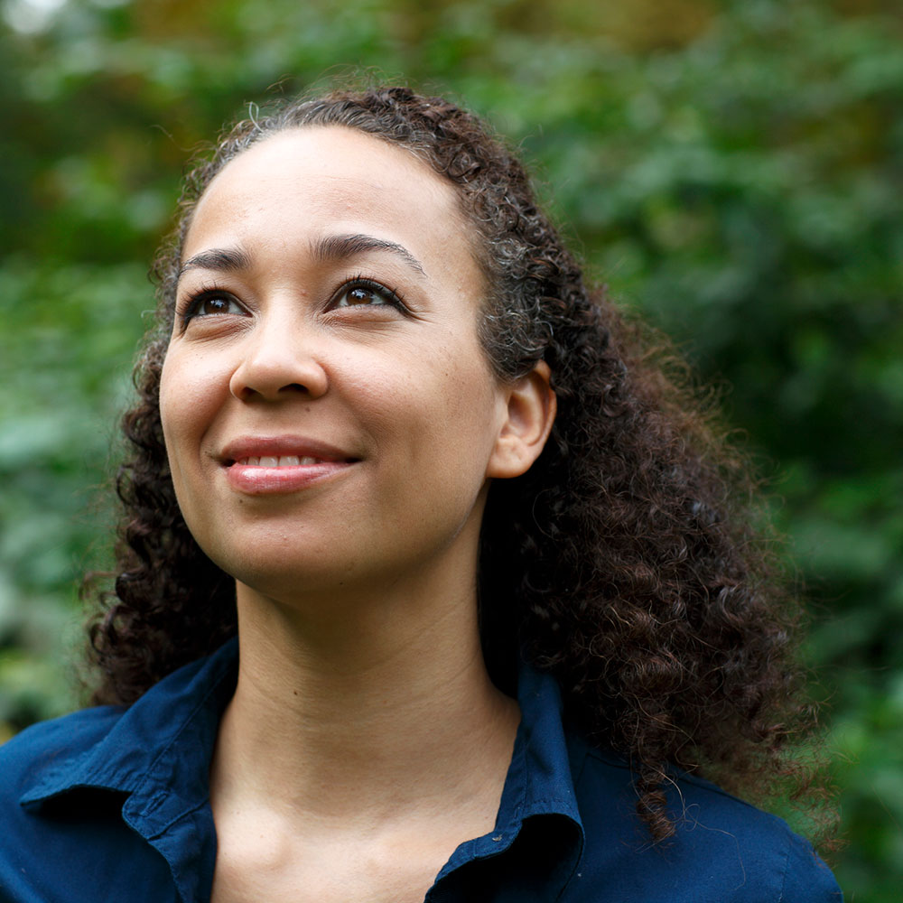 Mixed race woman in nature, smiling