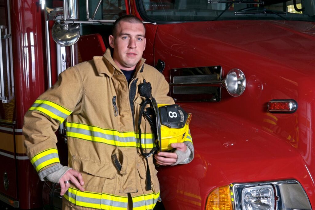 Firefighter in front of a fire truck